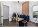 Spacious home office featuring wood floors, custom wood slat wall, and a modern desk with dark blue credenza at 12857 E Rosewood Dr, Scottsdale, AZ 85255