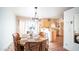 Bright dining area with tile floors and a decorative chandelier and large window at 13023 N Joan D Arc Ave, Phoenix, AZ 85032