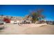 Desert home with mature landscaping, desert trees, bougainvillea, and circular driveway at 13023 N Joan D Arc Ave, Phoenix, AZ 85032