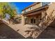This backyard features desert landscaping and a covered patio at 1421 E Hopkins Rd, Gilbert, AZ 85295