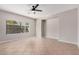 Spacious, naturally lit bedroom with tile flooring, a ceiling fan, and a large window at 1421 E Hopkins Rd, Gilbert, AZ 85295