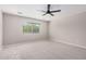Bright and airy bedroom with neutral walls, ceiling fan, and a large window with blinds at 1421 E Hopkins Rd, Gilbert, AZ 85295