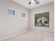 Bedroom with neutral carpet and walls and exterior view through multiple windows at 1421 E Hopkins Rd, Gilbert, AZ 85295