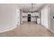Open kitchen with white cabinets, black appliances, and ample space for dining at 1421 E Hopkins Rd, Gilbert, AZ 85295