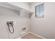 This laundry room features a window, tile floors, and laundry hook-ups at 1421 E Hopkins Rd, Gilbert, AZ 85295