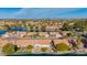 Aerial shot overlooking waterfront houses with red tile roofs by a lake in a suburban neighborhood at 1470 S Villas Ct, Chandler, AZ 85286