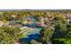 Stunning community aerial view with pool, tennis courts, lake, and lush landscaping at 1470 S Villas Ct, Chandler, AZ 85286