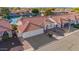 Beautiful aerial view of a lakefront home with a well-manicured lawn and a red tile roof at 1470 S Villas Ct, Chandler, AZ 85286