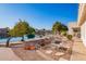 Picturesque backyard oasis with a well-manicured garden, mature citrus tree, and serene waterfront view at 1470 S Villas Ct, Chandler, AZ 85286