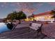 Backyard with a bench overlooking a canal, citrus trees, and decorative landscaping at 1470 S Villas Ct, Chandler, AZ 85286