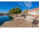Relaxing backyard scene with bench, citrus tree, and waterfront view creating a serene and inviting outdoor space at 1470 S Villas Ct, Chandler, AZ 85286
