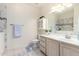 Bathroom featuring dual sinks, a soaking tub, and a separate toilet area at 1470 S Villas Ct, Chandler, AZ 85286