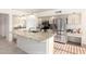 Bright kitchen featuring granite countertops, stainless steel appliances, and a functional island with a sink at 1470 S Villas Ct, Chandler, AZ 85286