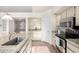 Well-lit kitchen showcasing granite countertops, white cabinets, and modern stainless steel appliances at 1470 S Villas Ct, Chandler, AZ 85286