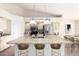 Charming kitchen features a granite island with pendant lights and seating, complemented by stainless steel appliances at 1470 S Villas Ct, Chandler, AZ 85286