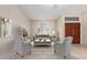 Warm and inviting living room features a neutral palette with tile floors, a large window, and comfortable seating arrangement at 1470 S Villas Ct, Chandler, AZ 85286