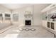 Bright and open living area features large windows, tile flooring, a fireplace, and built-in shelving for storage at 1470 S Villas Ct, Chandler, AZ 85286