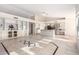 Open-concept living room flows into the kitchen, featuring built-in cabinets, tile floors, and lots of natural light at 1470 S Villas Ct, Chandler, AZ 85286