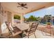 Covered patio with a tiled table and seating overlooking a serene waterfront view at 1470 S Villas Ct, Chandler, AZ 85286