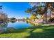 Beautiful waterfront view showcasing the tranquil lake, lush greenery, and inviting backyard spaces at 1470 S Villas Ct, Chandler, AZ 85286