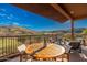 Inviting balcony with dining table and comfortable chairs overlooking a golf course and desert scenery at 16341 E Links Dr, Fountain Hills, AZ 85268