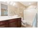 Bathroom showcasing double sinks with dark wood cabinets, decorative accents, and a shower with glass door at 16341 E Links Dr, Fountain Hills, AZ 85268