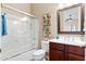Bathroom showcasing dark wood cabinets, decorative accents, a shower with glass door, and large mirror over vanity at 16341 E Links Dr, Fountain Hills, AZ 85268