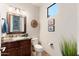 Elegant powder room featuring granite countertops, decorative mirror, and bright natural lighting at 16341 E Links Dr, Fountain Hills, AZ 85268