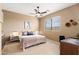 Comfortable bedroom featuring a ceiling fan, carpeted floors and a picturesque view from the bright, sunny window at 16341 E Links Dr, Fountain Hills, AZ 85268