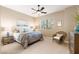 Comfortable bedroom featuring a ceiling fan, carpeted floors and a picturesque view from the bright, sunny window at 16341 E Links Dr, Fountain Hills, AZ 85268