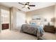 Comfortable bedroom with a view of the attached bathroom and featuring a ceiling fan and carpeted floors at 16341 E Links Dr, Fountain Hills, AZ 85268