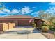 Charming single-story home with a three-car garage, tiled roof, and an American flag at 16341 E Links Dr, Fountain Hills, AZ 85268