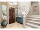 Welcoming foyer with elegant decor, tiled floors, and a staircase leading to the upper level at 16341 E Links Dr, Fountain Hills, AZ 85268