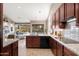 Well-equipped kitchen with stainless steel appliances, granite countertops, and an open flow to the living area at 16341 E Links Dr, Fountain Hills, AZ 85268