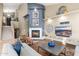 Cozy living room with a fireplace, television, and modern decor leading to a staircase at 16341 E Links Dr, Fountain Hills, AZ 85268