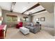 Large living room offering exposed beams, two windows with picturesque views, comfortable seating, and carpeted floors at 16341 E Links Dr, Fountain Hills, AZ 85268