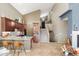 Open-concept living space with high ceilings and tile flooring showcasing the kitchen, staircase, and front door at 16341 E Links Dr, Fountain Hills, AZ 85268