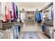 Well-organized walk-in closet with custom shelving, rods, and a stylish area rug at 16341 E Links Dr, Fountain Hills, AZ 85268