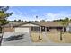 Inviting single-story home showcasing its brick facade and landscaped front yard under a bright blue sky at 1656 E Halifax St, Mesa, AZ 85203