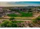A sprawling view of the community, showcasing lush green spaces and modern residential buildings under a bright, sunny sky at 1701 E Colter St # 191, Phoenix, AZ 85016