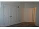 Neutral bedroom featuring light gray wood floors, double doors, and white walls at 1701 E Colter St # 191, Phoenix, AZ 85016