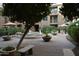 Serene courtyard featuring a decorative fountain, comfortable benches, and shaded seating areas at 1701 E Colter St # 191, Phoenix, AZ 85016