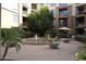 Charming courtyard with a fountain, seating areas, and lush landscaping at 1701 E Colter St # 191, Phoenix, AZ 85016