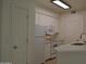 Bright kitchen features white appliances, white cabinetry, and quartz countertops at 1701 E Colter St # 191, Phoenix, AZ 85016
