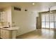 An open floor plan reveals tile flooring and bright light from the sliding door in this condo at 1701 E Colter St # 191, Phoenix, AZ 85016