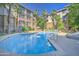Beautiful pool with lounge chairs surrounded by palm trees and lush landscaping at 1701 E Colter St # 191, Phoenix, AZ 85016