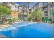 Resort-style swimming pool with lounge chairs and palm trees, perfect for relaxing and enjoying the sun at 1701 E Colter St # 191, Phoenix, AZ 85016
