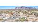 Stunning aerial view of desert home with mountain backdrop and expansive desert landscaping at 1727 E Hidalgo St, Apache Junction, AZ 85119