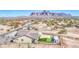 Panoramic aerial view of a desert house with artificial grass, sunshade, and mountain views at 1727 E Hidalgo St, Apache Junction, AZ 85119