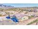 Expansive aerial view of a charming desert home featuring desert landscaping and a majestic mountain backdrop at 1727 E Hidalgo St, Apache Junction, AZ 85119